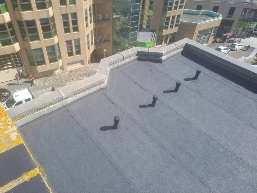 Aerial view of completed flat roof with vent stacks, Brighton